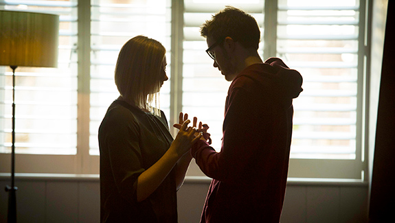man-observing-stoma-pouch-on-his-abdomen-thinking-about-body-image-concerns-with-a-stoma